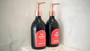 Two bottles of WAHID prime shower gel and conditioner on a marble surface. - Wahid Prime Hotel Salatiga (Salatiga)