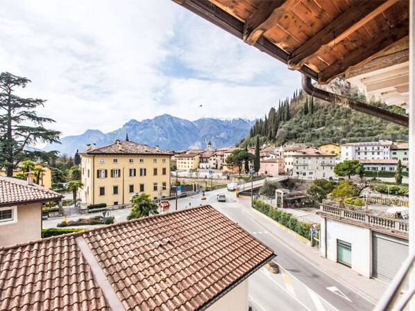 A town with buildings, a road, and mountains in the background.