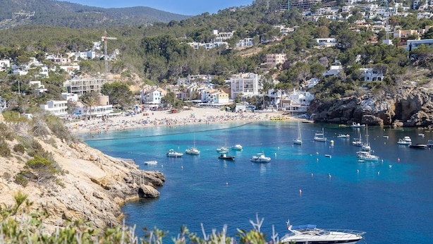 A coastal town with a beach, boats, and buildings. - Oceanfront Retreat in Sant Josep de sa Talaia With Shared Pool (Sant Josep de sa Talaia)