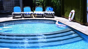 A swimming pool with lounge chairs and a lifebuoy. - Millsview hotel (Kisumu)