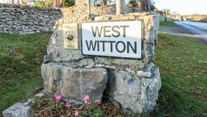 A stone sign with 'WEST WITTON' and a 'NEIGHBOURHOOD WATCH' sign. - Valley View (Leyburn)