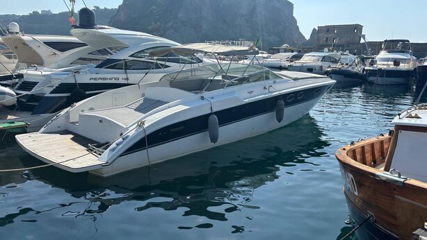 A marina with several yachts docked, including a white yacht named 'Pershing 46'. - Fall in Love With the Amalfi Coast Charming Boat Rental in Naples (Naples)