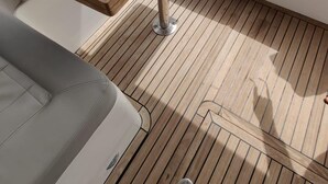 A wooden table with metal legs on a boat deck. - Luxurious Caprie Italia Boat Rental With Breathtaking Ocean Views (Capri)