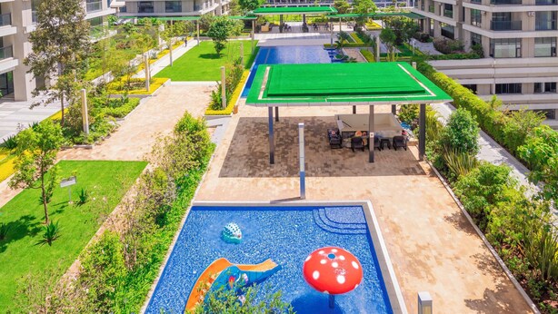 A modern residential complex with high-rise buildings, a swimming pool with a colorful mural, and well-maintained green spaces. - Executive 1 Br -Gtc with gym & Pool (Nairobi)