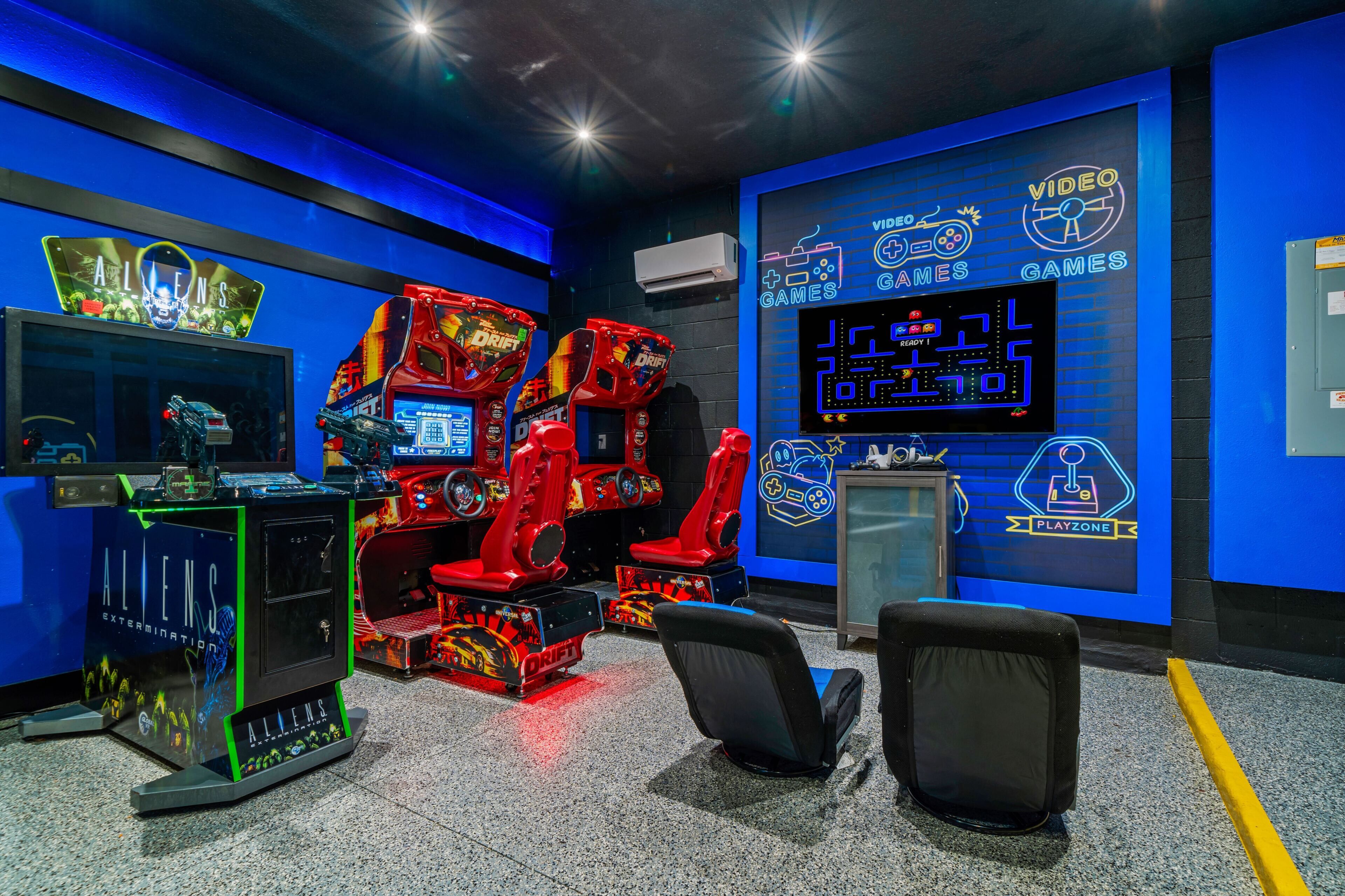 A gaming arcade with multiple racing game machines, a Playzone sign, and a neon sign for 'ALIENS EXTERMINATION'.