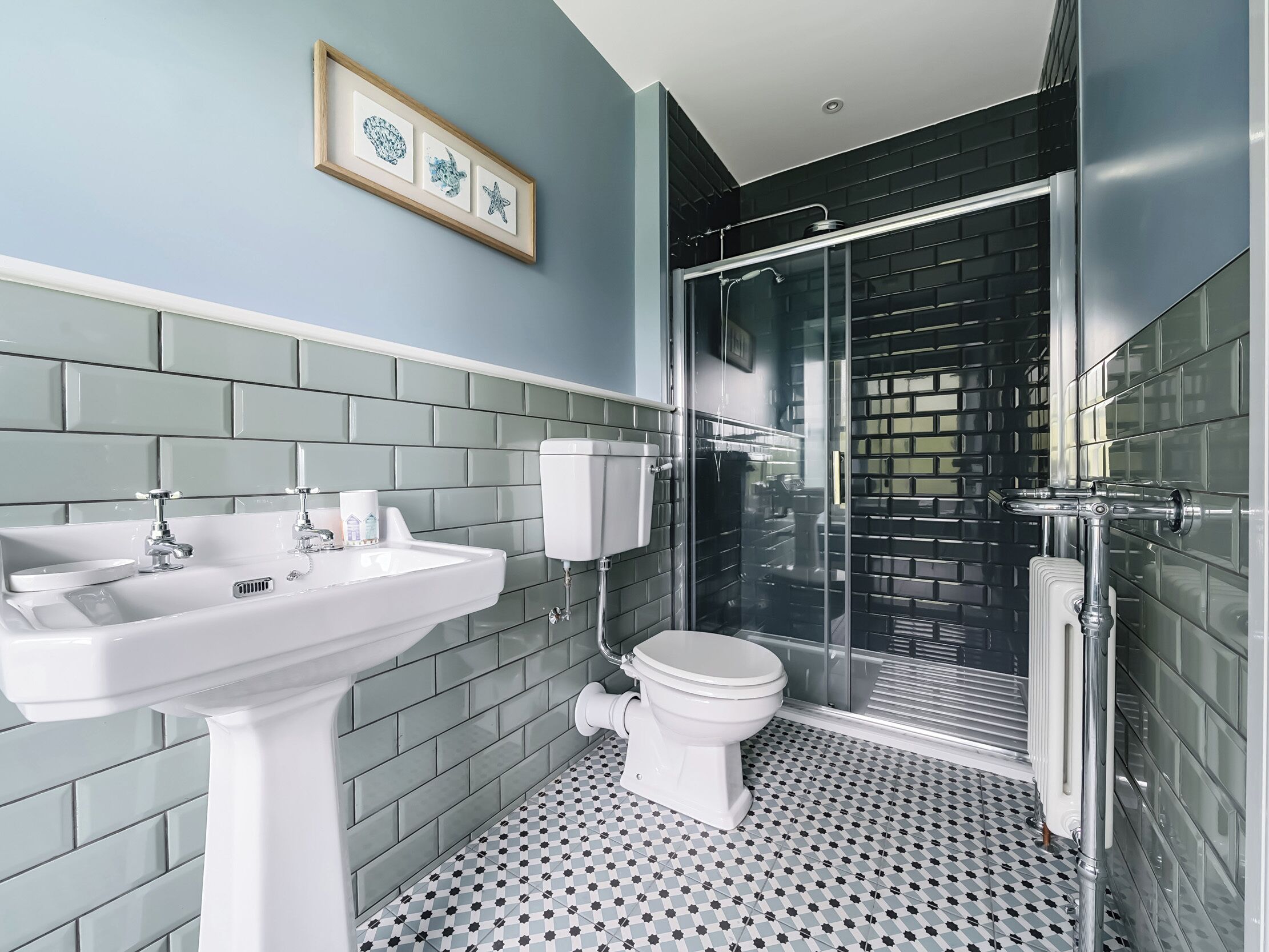 A bathroom with a sink, toilet, and shower.