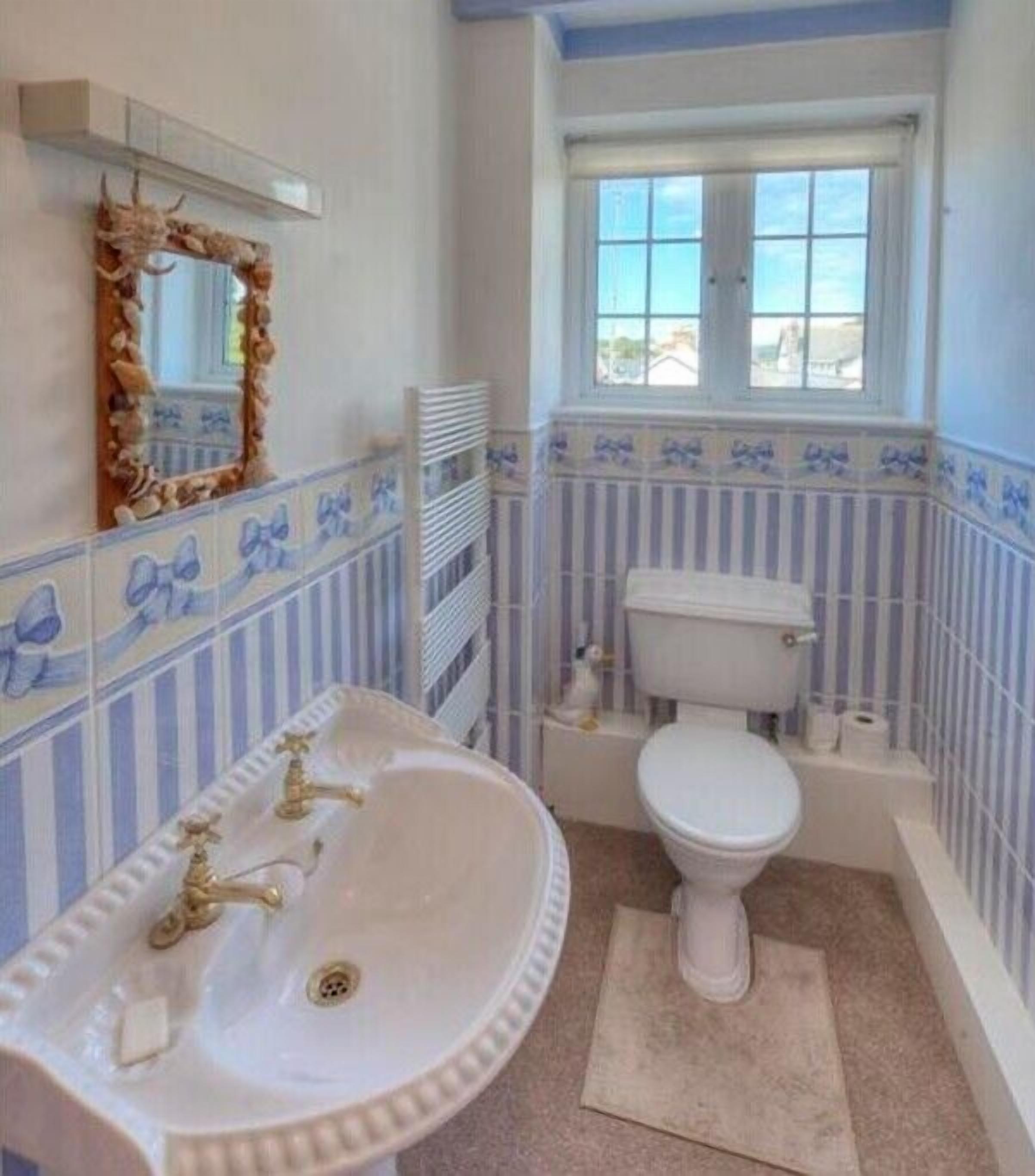 A bathroom with a white sink, toilet, and bathtub.