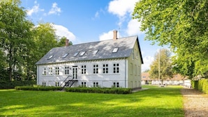 A large, two-story building with a symmetrical facade, multiple windows, and a central staircase. - Kragsbjerggaard Hotel (Odense)
