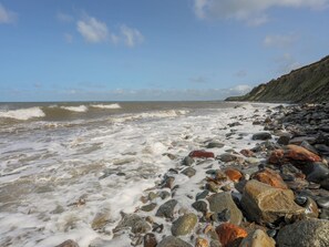 A rocky beach with waves crashing onto the shore. - Tal Eryr (Caernarfon)