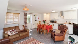 A compact living space with a dining area, kitchenette, and seating.