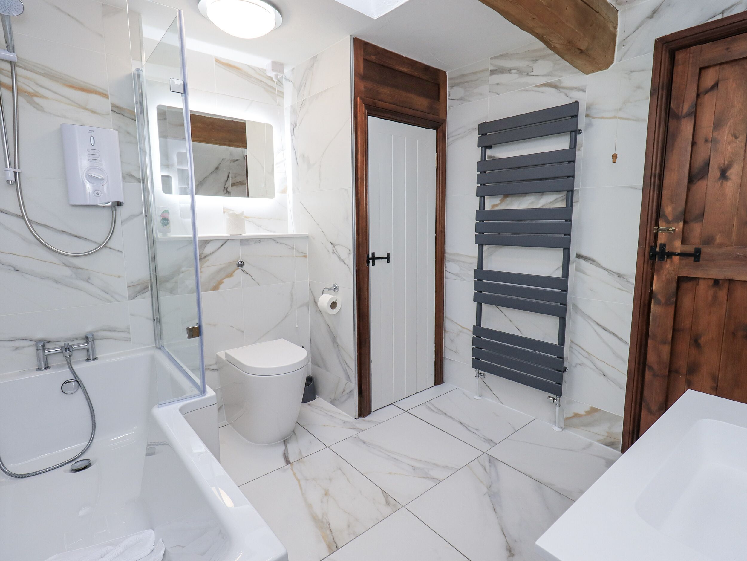 A bathroom with a bathtub, toilet, and shower.