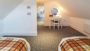 A room with a white desk, a chair, a round mirror, and a lamp. There is a staircase leading to another room. - Fasgadh (Perth)