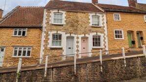 A stone building with two visible doors, one labeled "PENDENNS" and the other "MATCHBOX". - Pendennis (Sherborne)