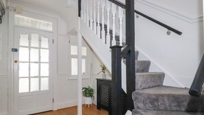 A staircase with white balusters and a black handrail leading to a landing. - 119 Henver Road (Newquay)