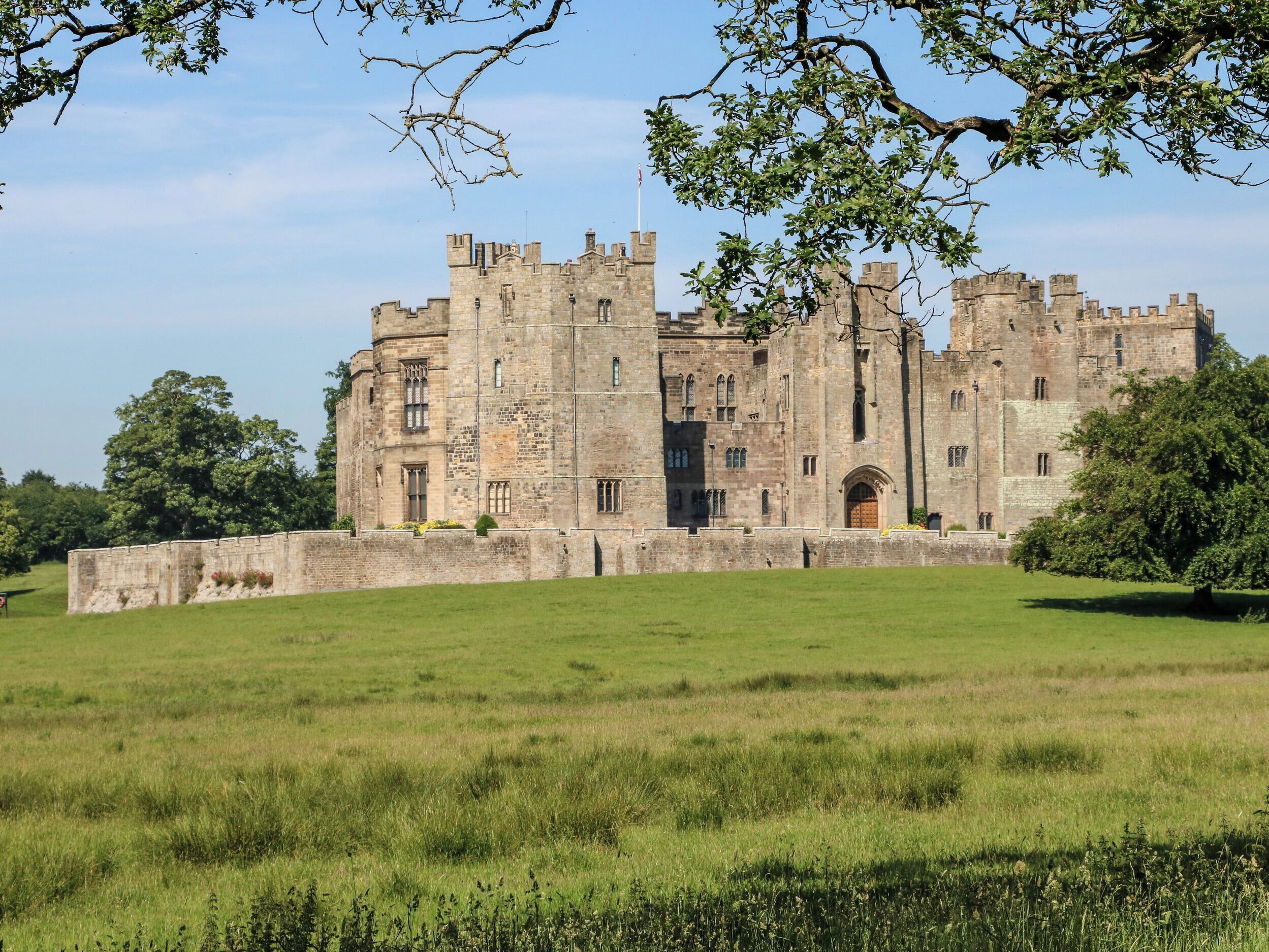 A large, historic castle with multiple towers and a prominent entrance.