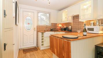 Fridge, electric kettle, toaster, cookware/dishes/utensils