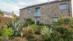 A stone house with a garden in front.