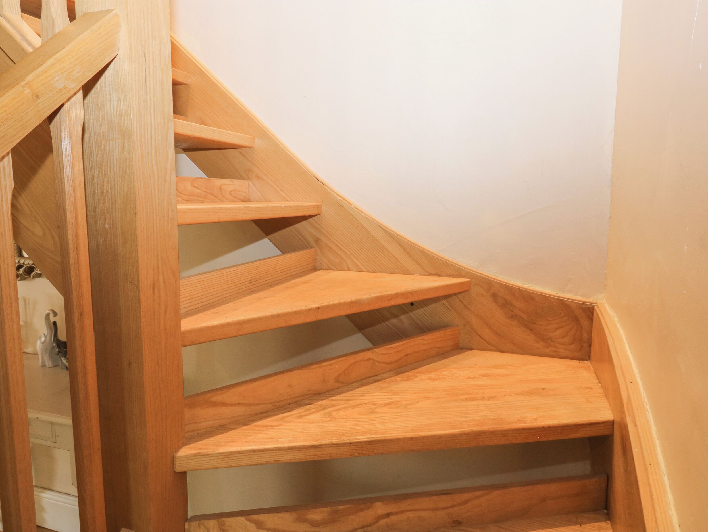 A wooden spiral staircase with multiple steps.