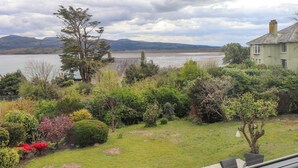 A house with a view of a lake and mountains.