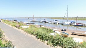 A marina with various boats docked along the shore. - Crab Corner (Wells-next-the-Sea)