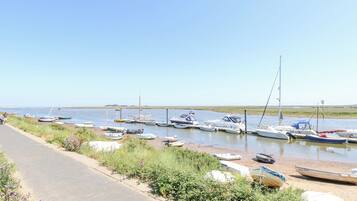 A marina with various boats docked along the shore.