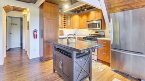 A modern kitchen with wooden cabinets, stainless steel appliances, and a central island. - Family-friendly Lake Arrowhead Cabin w/ Game Room! (Lake Arrowhead)