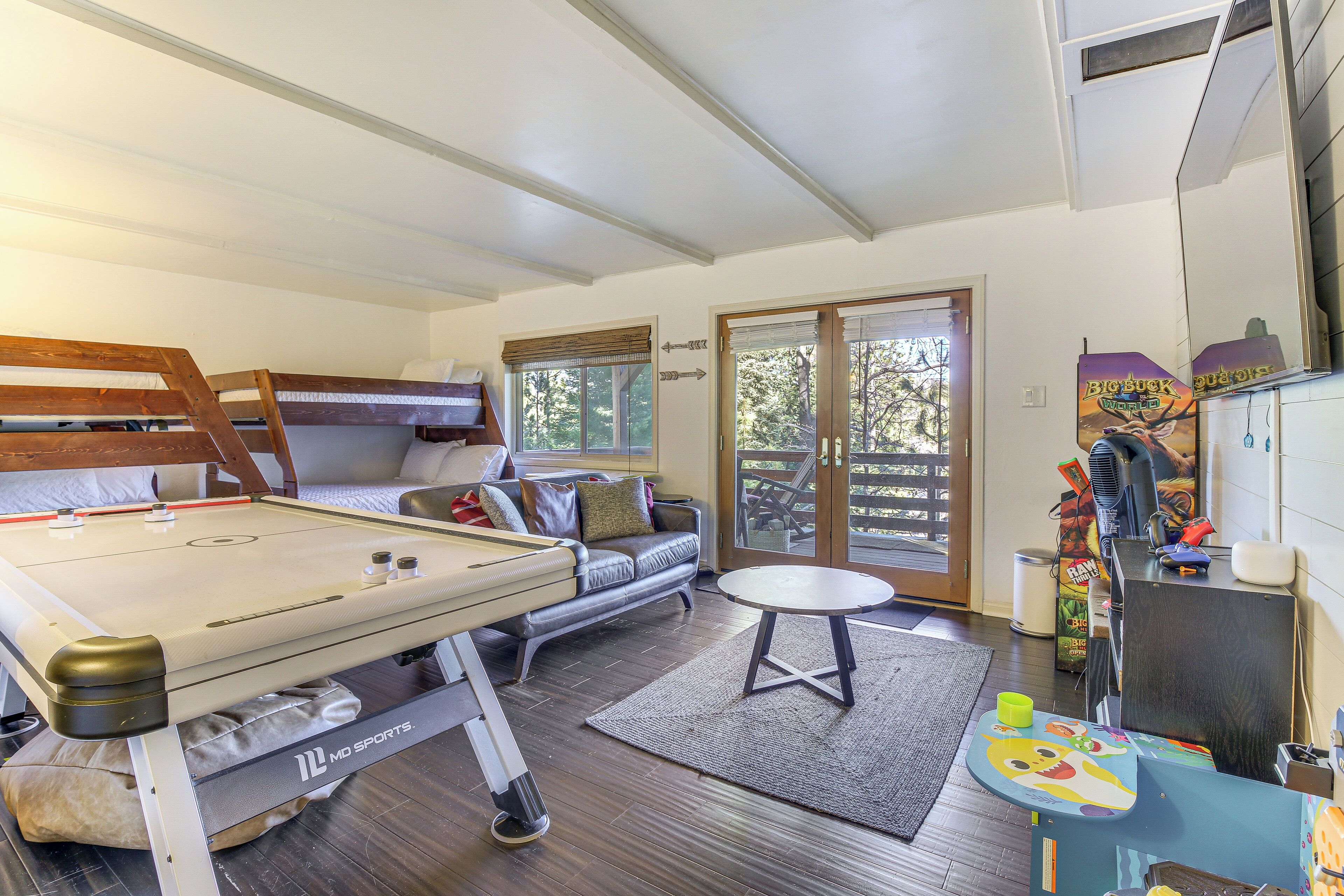 A cozy room with a pool table, a sofa, and a small table with a toy.