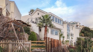 A residential building with a modern architectural style, featuring a two-story structure with large windows and a flat roof. - The Grottoes (Torquay)