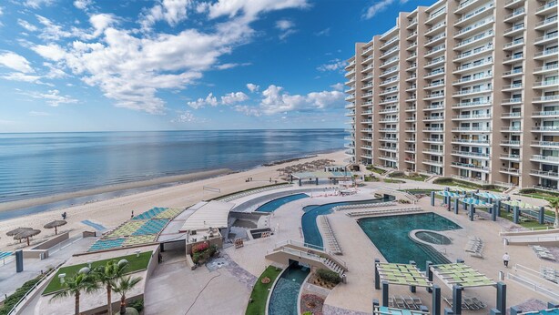 A resort with a pool area, beach, and ocean view. - Las Palomas Phase II Coronado 503 Exceptional OceanFront 3BR 2BA Unit. (Puerto Peñasco)
