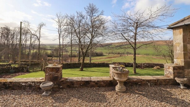 A stone building with a view of a green landscape and trees. - Cragg Lodge (Hexham)