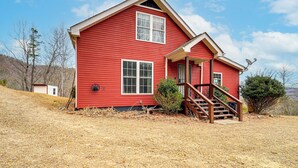 A red house with a front porch and a staircase leading to the entrance. - Dog Friendly Mountain View Retreat w/ Hot Tub (Purlear)