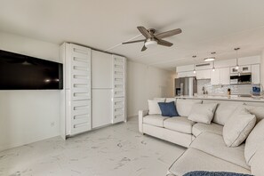 A modern kitchen with white cabinets, a built-in oven, and a microwave. - Dogs Welcome: Beachfront South Padre Island Condo (South Padre Island)