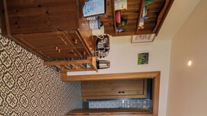 Una cocina compacta con estufa integrada, una ventana y encimera de madera.