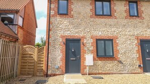 A two-story building with a stone facade and red-tiled roof. - Clavering 1 Bernaleen Cottages (King's Lynn)
