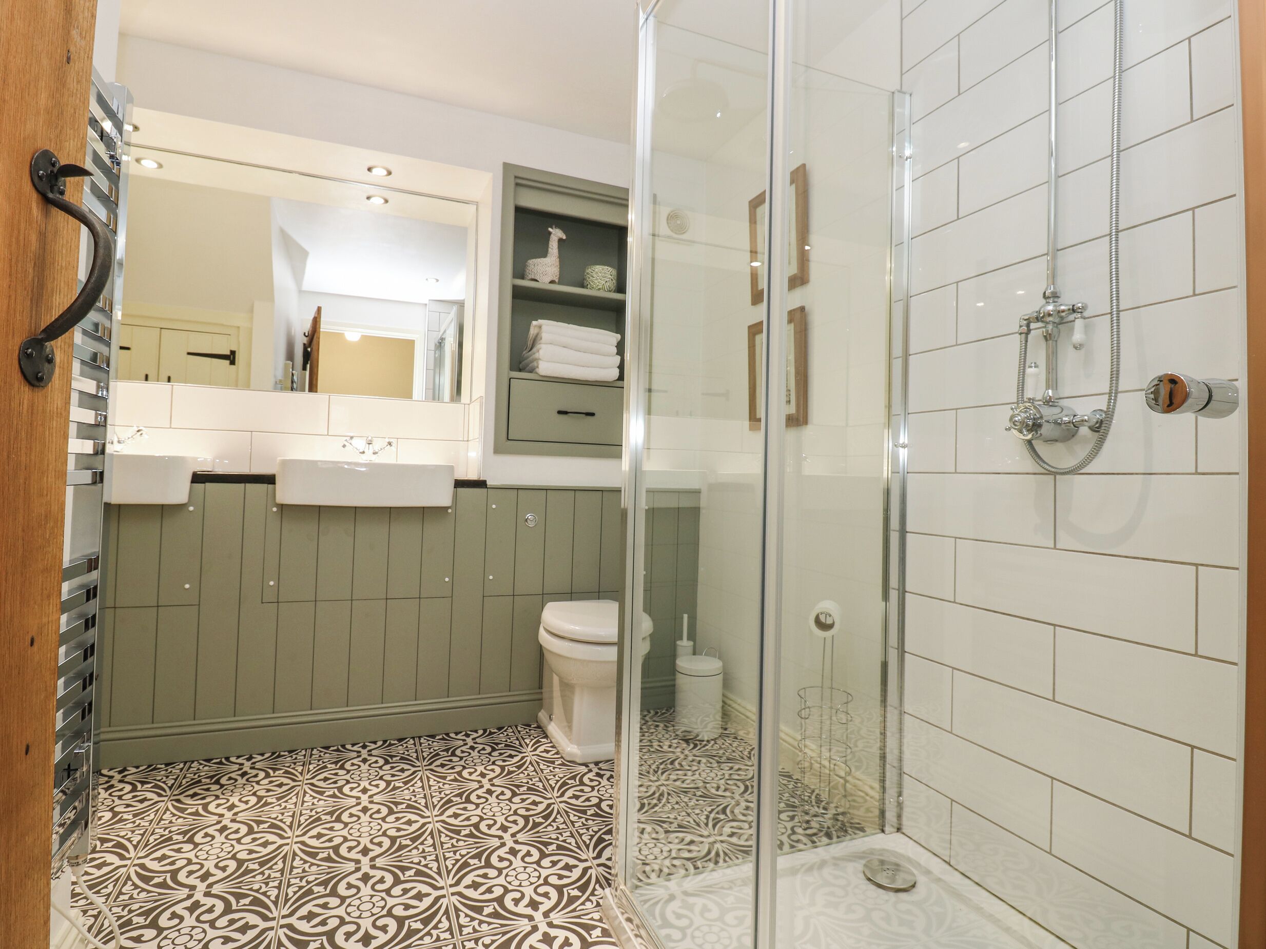 A bathroom with a shower, toilet, and sink.