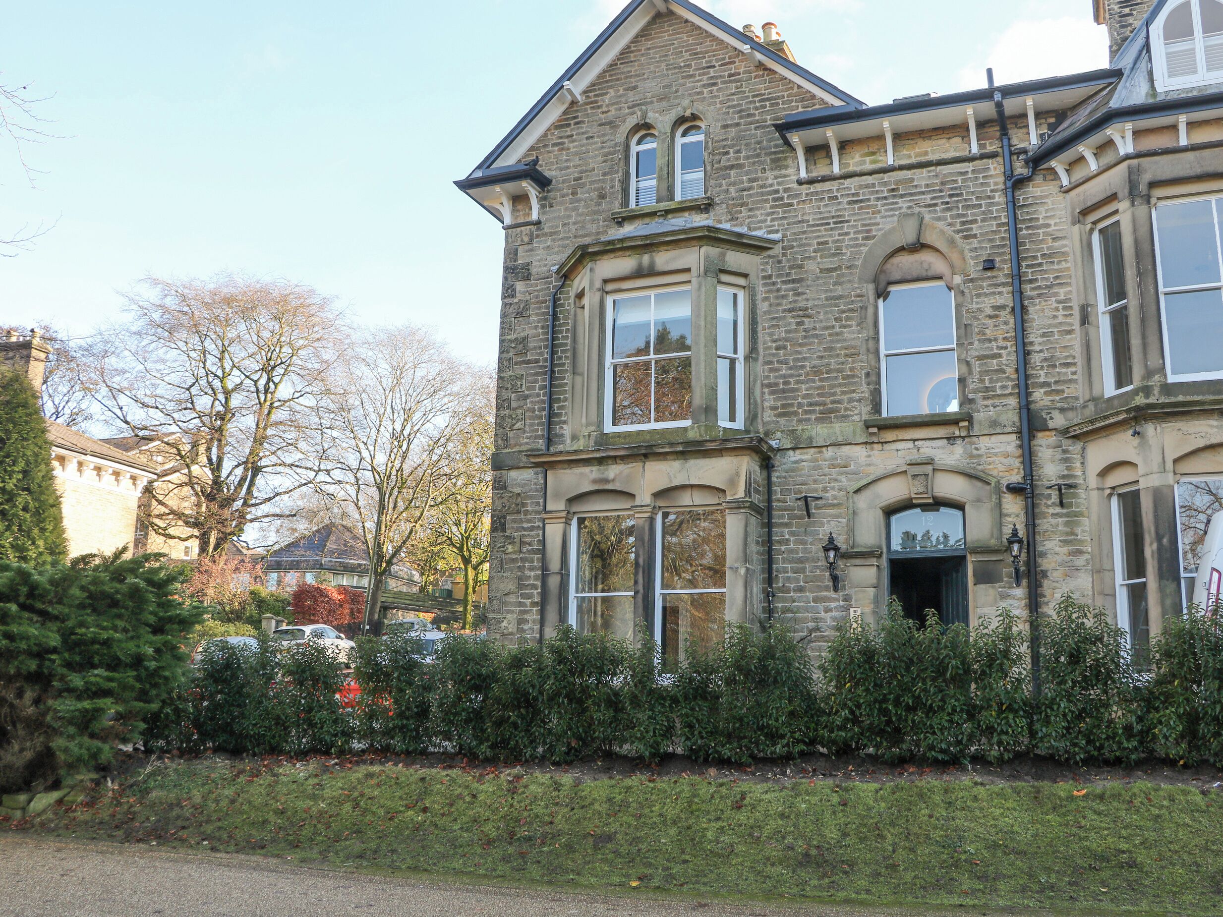 A stone building with multiple windows and a traditional architectural style.