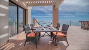 Enjoy al fresco dining on the terrace with a hammock and wicker chairs.