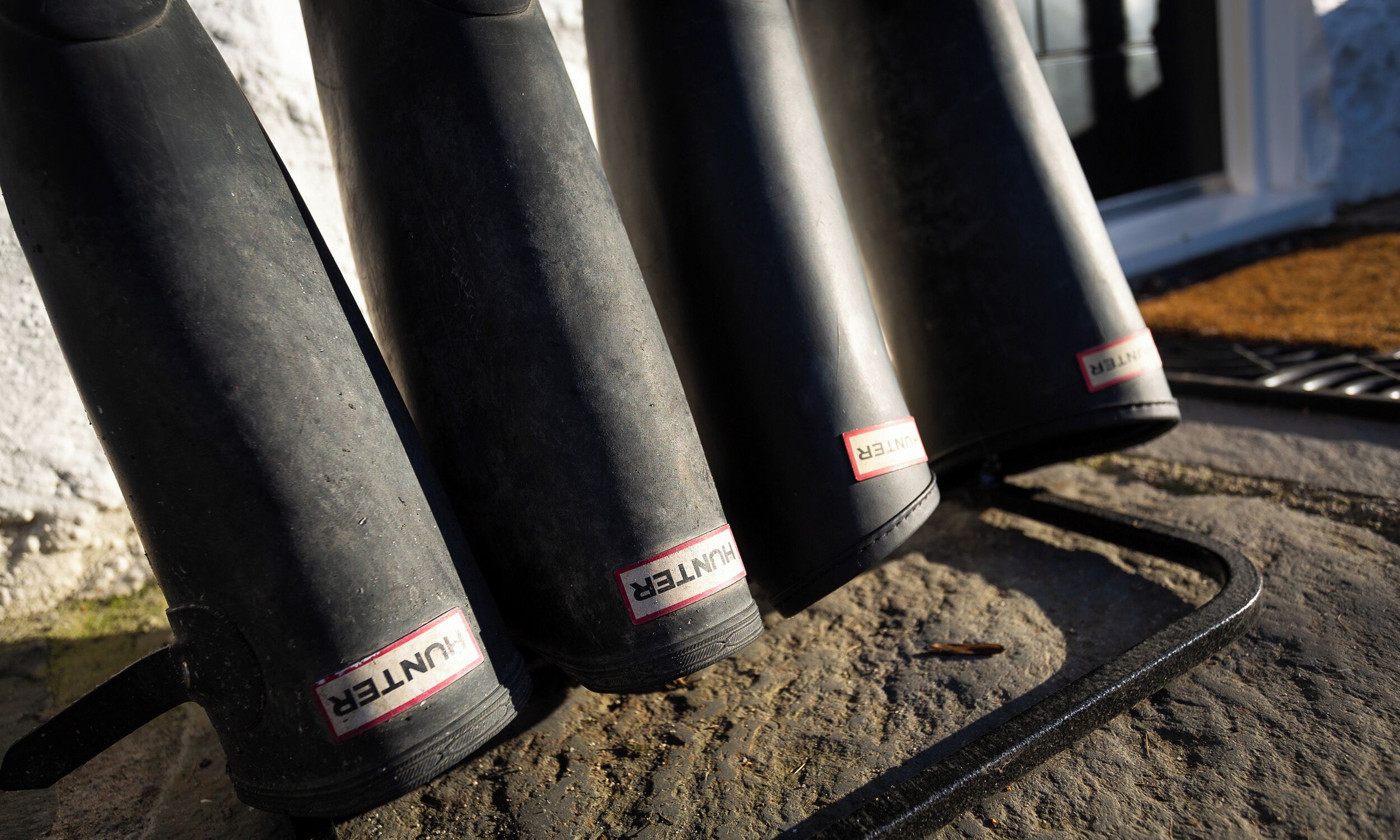 A row of black tires with "HUNTER" labels on a metal rack.