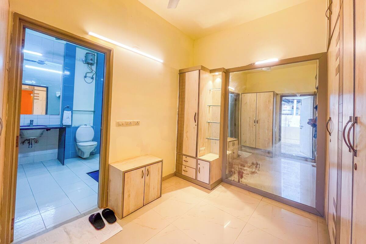 A bathroom with a toilet, sink, and shower area.