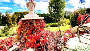 A sculpture with a bust on a pedestal surrounded by autumn foliage. - Guest Room, Enjoy the peaceful Bernese Seeland (Grossaffoltern)