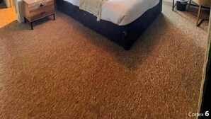 A bedroom with a large bed, a desk with a chair, a ceiling fan, and a window with curtains. - Old Mill Salisbury (Salisbury)