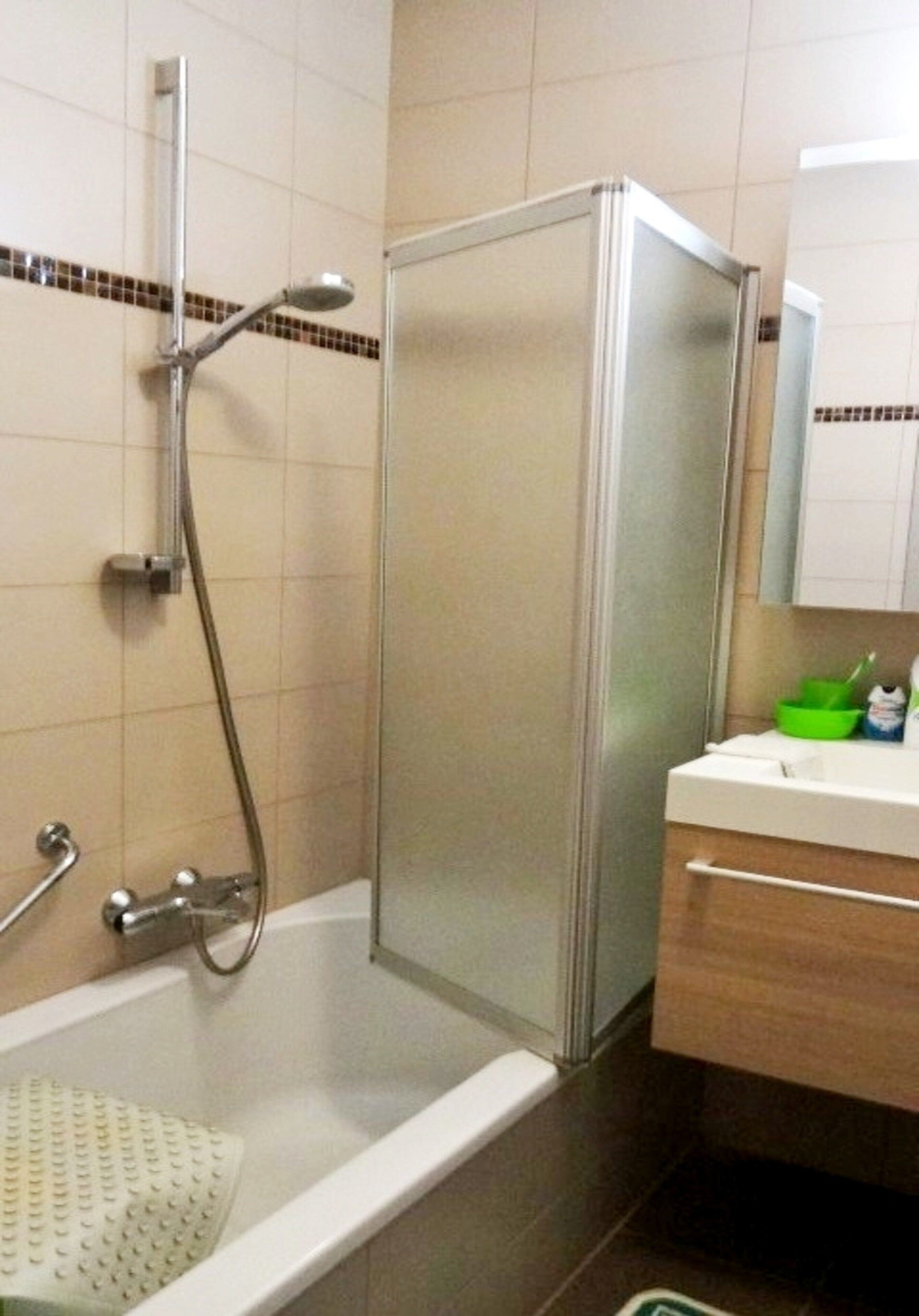 A bathroom with a walk-in shower, a bathtub, and a vanity with a mirror.