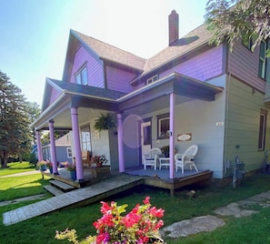 A two-story house with a porch, a chimney, and a number '43' sign.