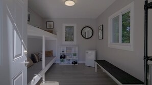 A hallway with a bench, a small refrigerator, and a window with a view of trees. - Cozy Bunkie by a Tranquil Freshwater Pond in Clarington, Ontario (Bowmanville)