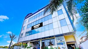 A modern building with a sign reading "PALETTE & Corporate Services." - Luxury Stays With Pool Near Akshardham Temple (Jaipur)