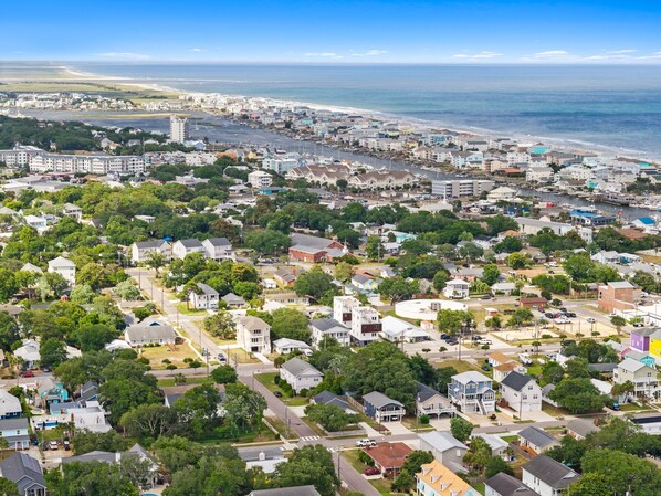 A coastal town with residential houses, a marina, and a beach.