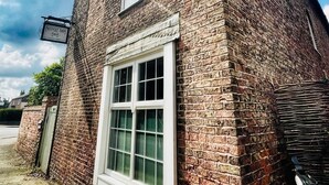 A brick building with a large window and a sign that reads "Mayfield Farm B&B." - Maypole Farm Guest House (Selby)