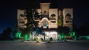 A building with a sign reading "PALETTE" and a large tree in front. - Elegant Escape in Palette Bhimpore Daman (Daman)