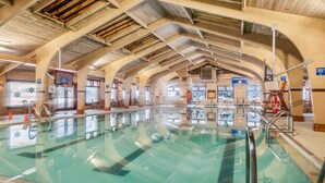 An indoor swimming pool with clear water, a basketball hoop, and a lounge area with seating. - ❄ The Snowballer – Ultimate Ski-In/Ski-Out Retreat! 🎿🏔 (Champion)