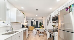 Enjoy a spacious kitchen, dining area, and cozy living space with a fireplace, plus a balcony with city views.
